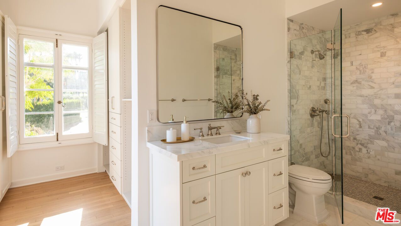 Bathroom, Dual Sink Vanities, Glass Shower, Interior, Marble Walls, Recessed Lighting, Wood Texture Flooring