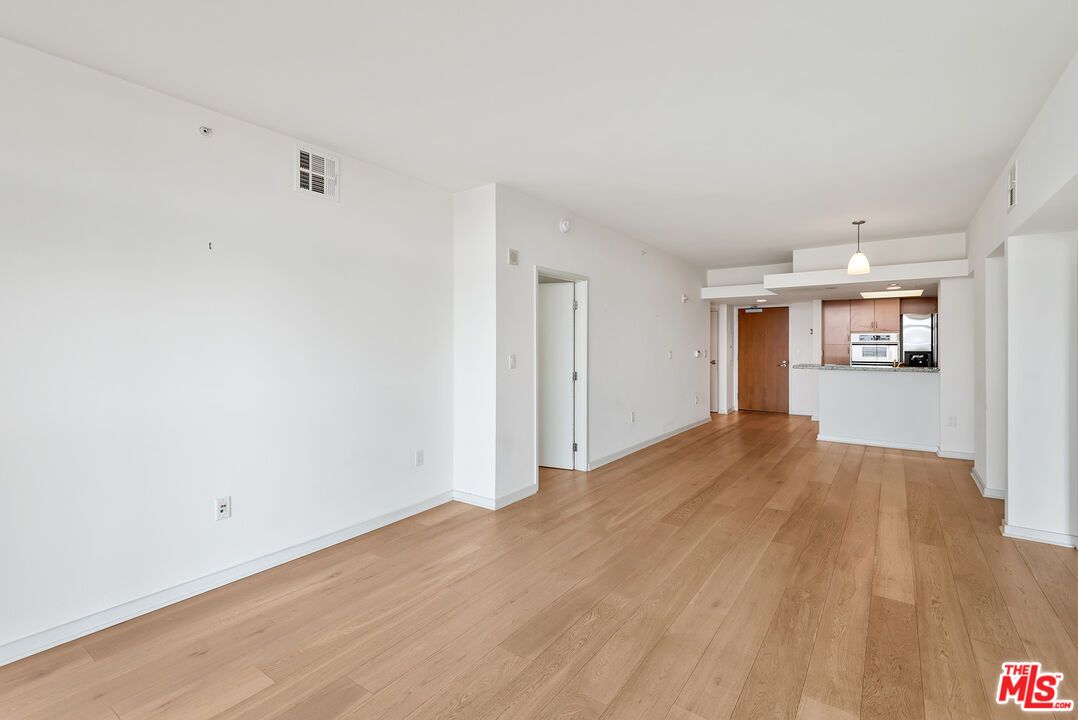 Empty room, Interior, Kitchen, Pendant Lights, Stainless Steel Appliances, Wood Texture Flooring