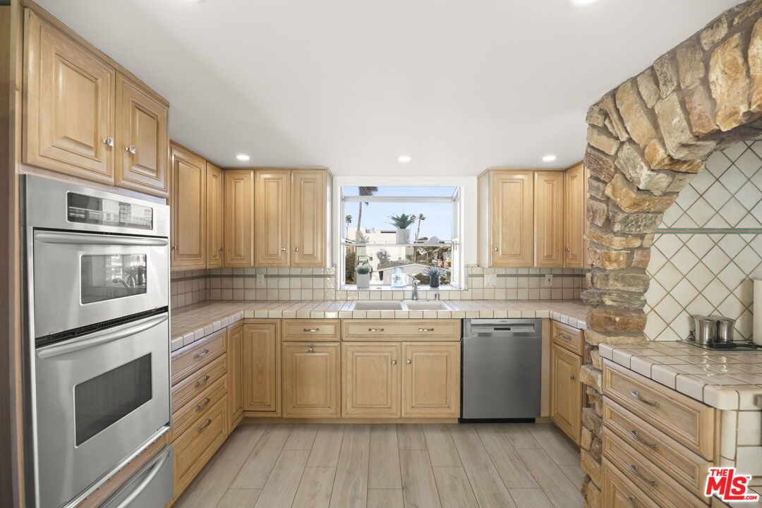 Interior, Kitchen, Recessed Lighting, Stainless Steel Appliances, Tile Countertops, Wood Texture Flooring