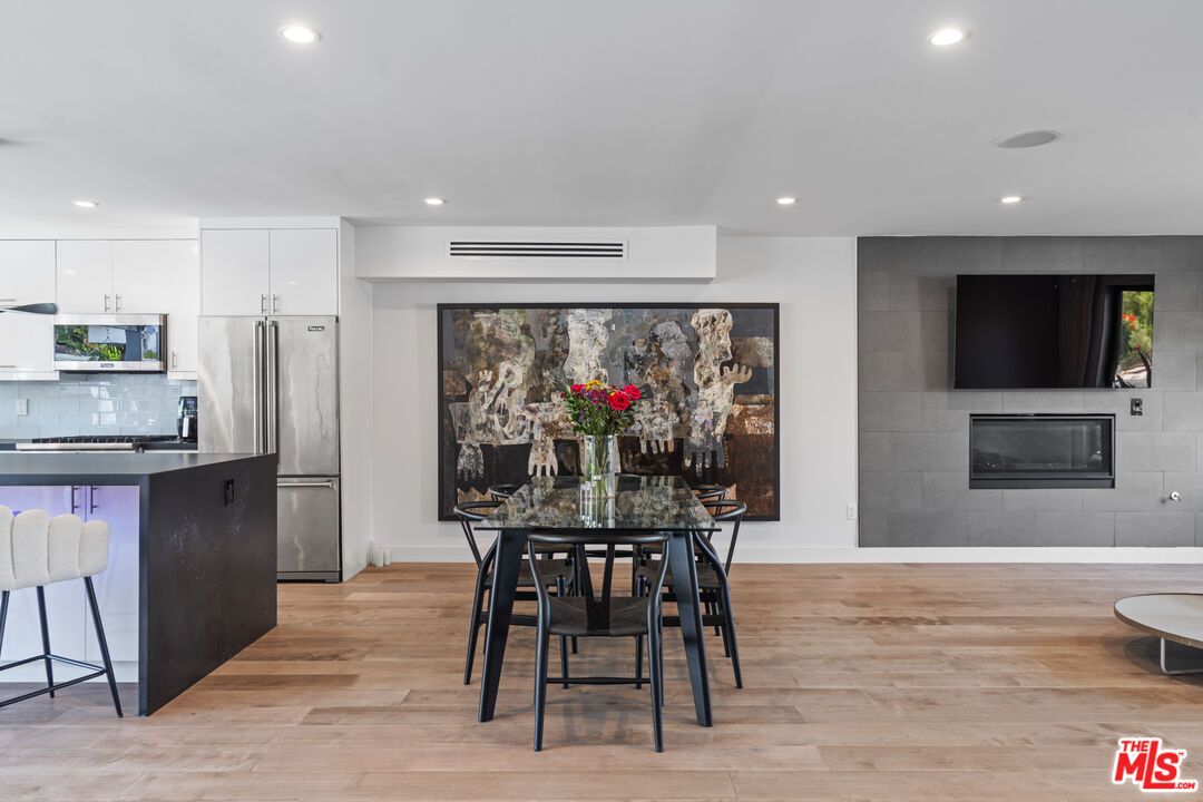 Dining room, Fireplace, Interior, Kitchen, Recessed Lighting, Stainless Steel Appliances, Wood Texture Flooring