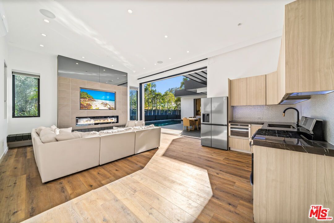 Fireplace, Interior, Kitchen, Living room, Recessed Lighting, Stainless Steel Appliances, Wood Texture Flooring