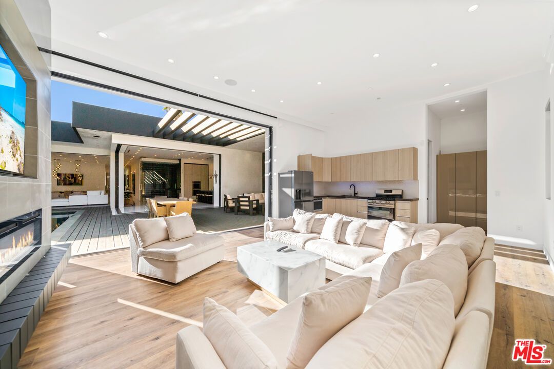 Dining room, Fireplace, Interior, Kitchen, Living room, Recessed Lighting, Stainless Steel Appliances, Wood Texture Flooring