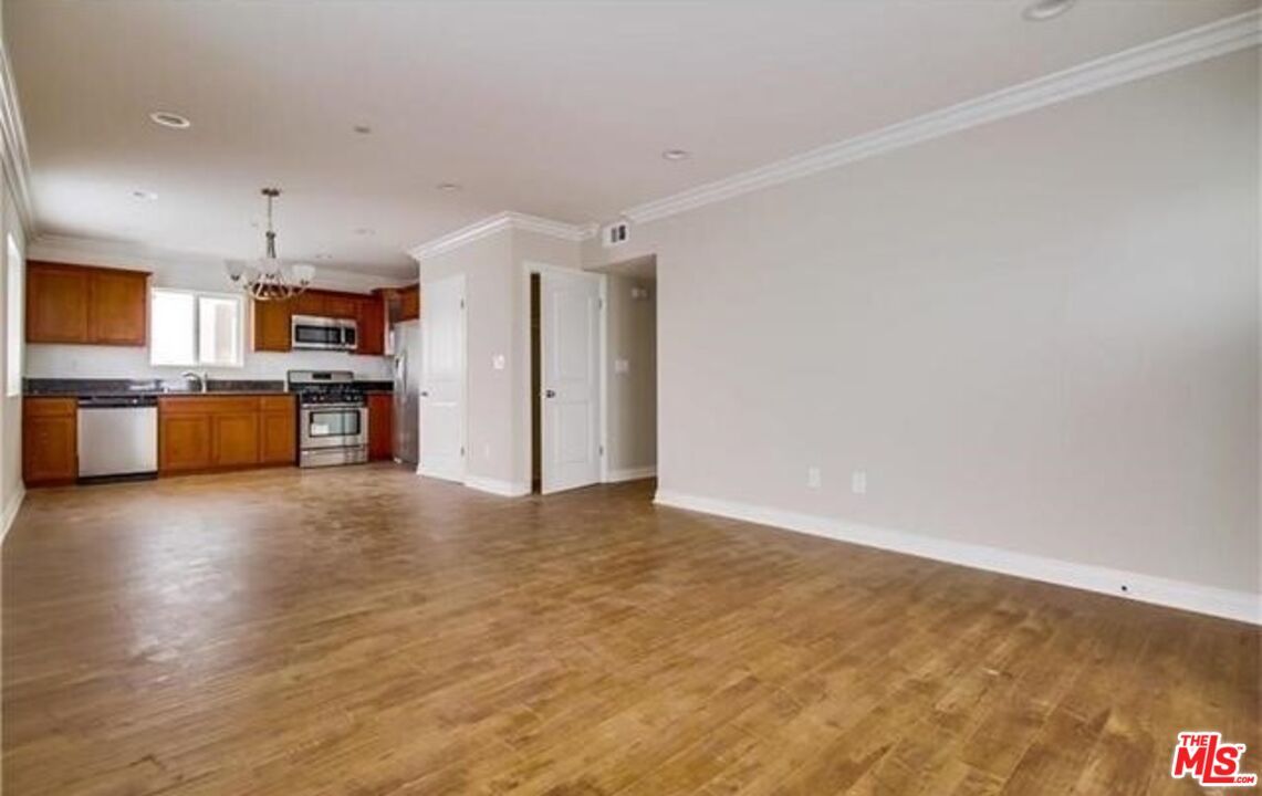 Chandelier, Empty room, Interior, Kitchen, Recessed Lighting, Stainless Steel Appliances, Wood Texture Flooring