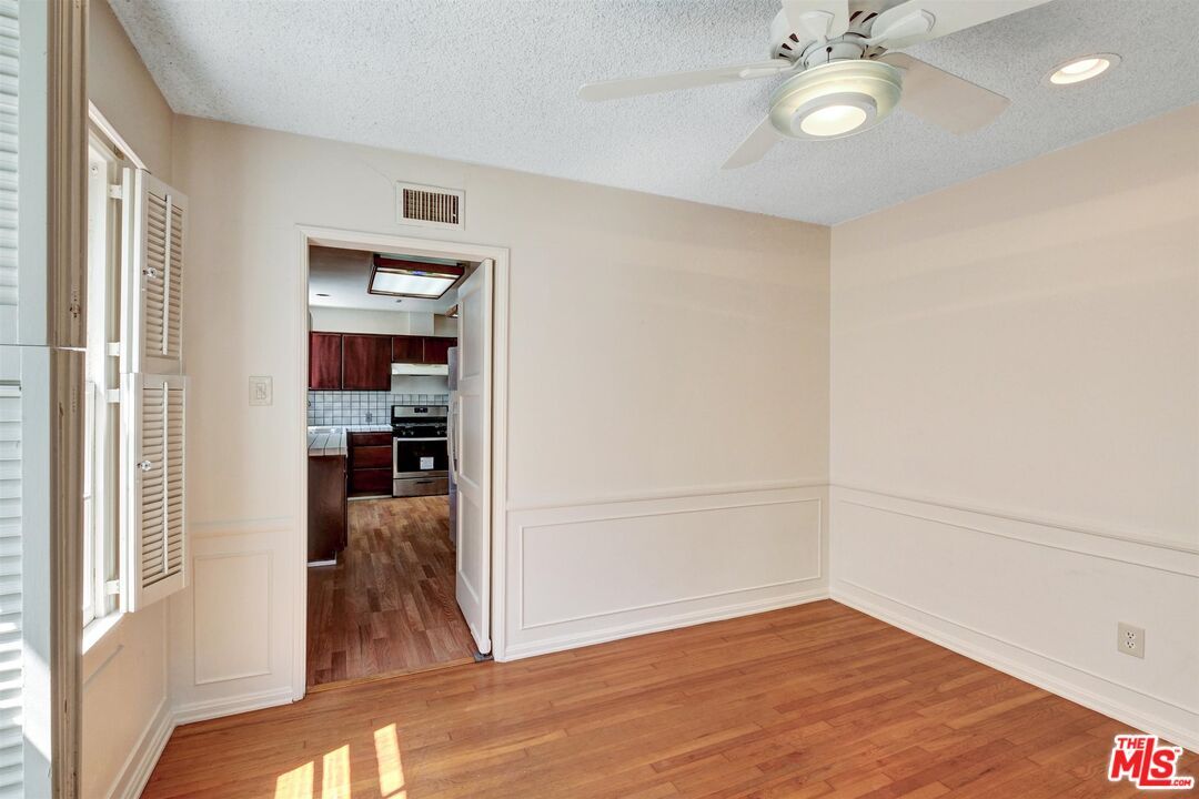 Empty room, Interior, Kitchen, Recessed Lighting, Stainless Steel Appliances, Wood Texture Flooring