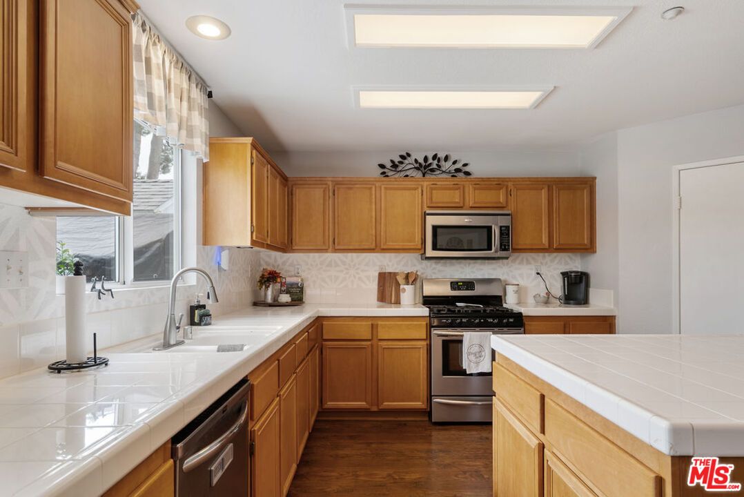 Interior, Kitchen, Recessed Lighting, Stainless Steel Appliances, Tile Countertops, Wood Texture Flooring