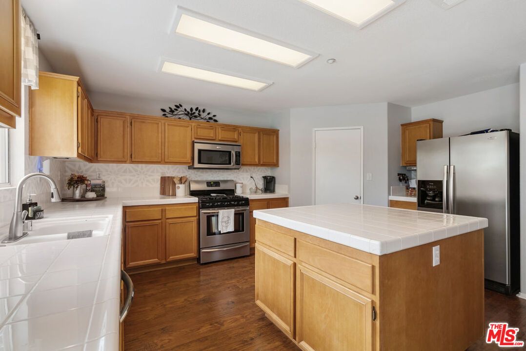 Interior, Kitchen, Recessed Lighting, Stainless Steel Appliances, Tile Countertops, Wood Texture Flooring