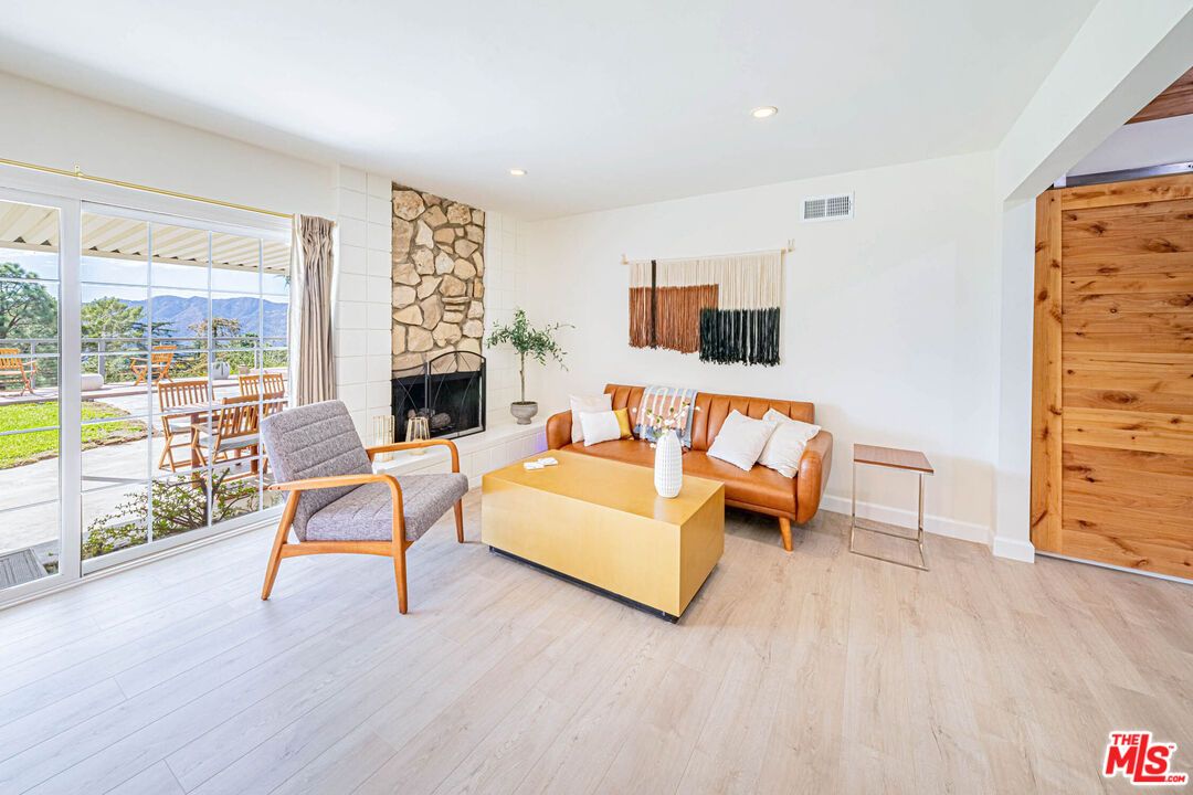 Fireplace, Interior, Living room, Recessed Lighting, Stone Walls, Wood Texture Flooring