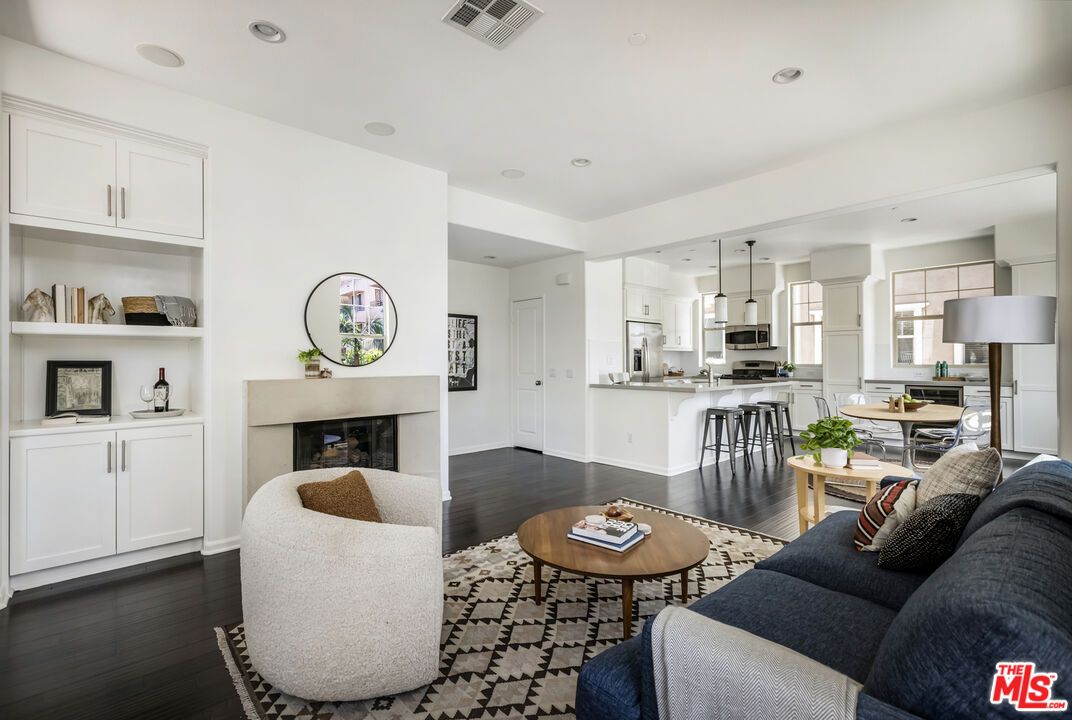 Fireplace, Interior, Kitchen, Living room, Pendant Lights, Recessed Lighting, Stainless Steel Appliances, Wood Texture Flooring