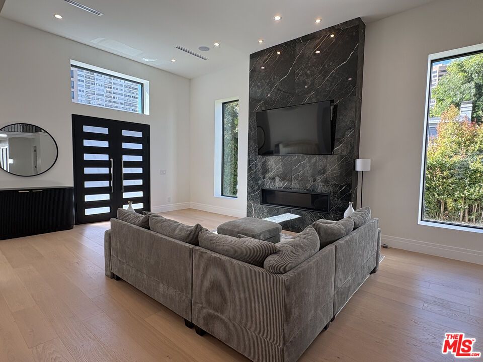 Fireplace, Interior, Living room, Marble Walls, Recessed Lighting, Wood Texture Flooring