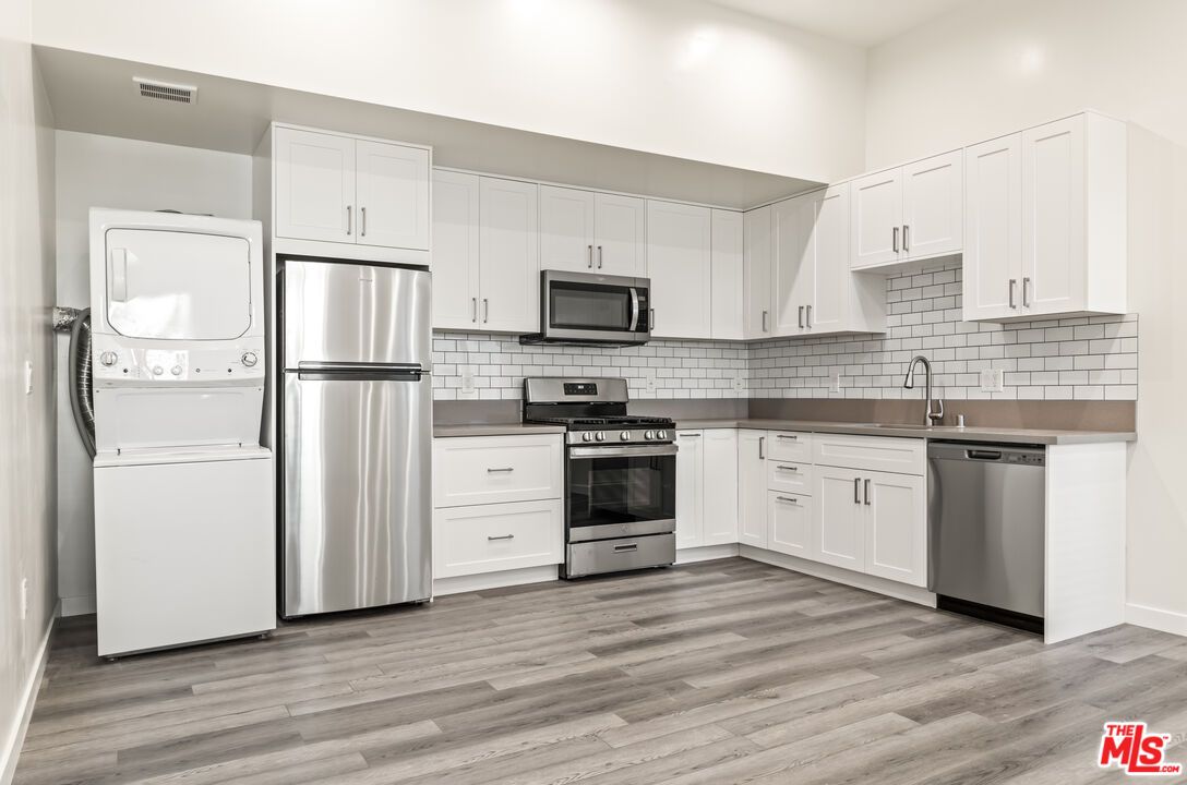 Interior, Kitchen, Recessed Lighting, Stainless Steel Appliances, Washer, Wood Texture Flooring