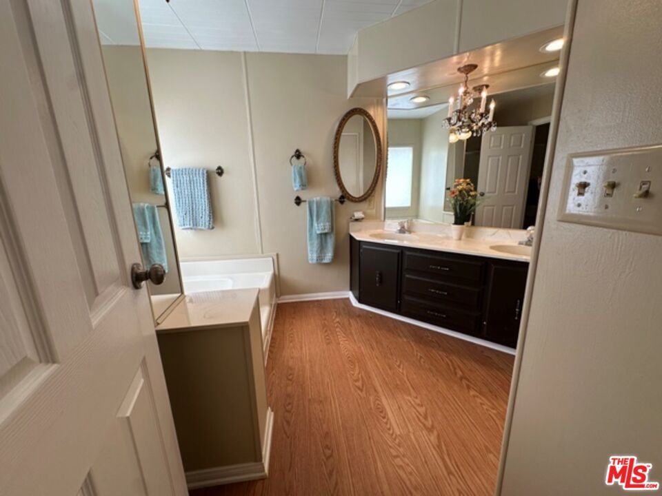 Bathroom, Chandelier, Dual Sink Vanities, Interior, Recessed Lighting, Wood Texture Flooring