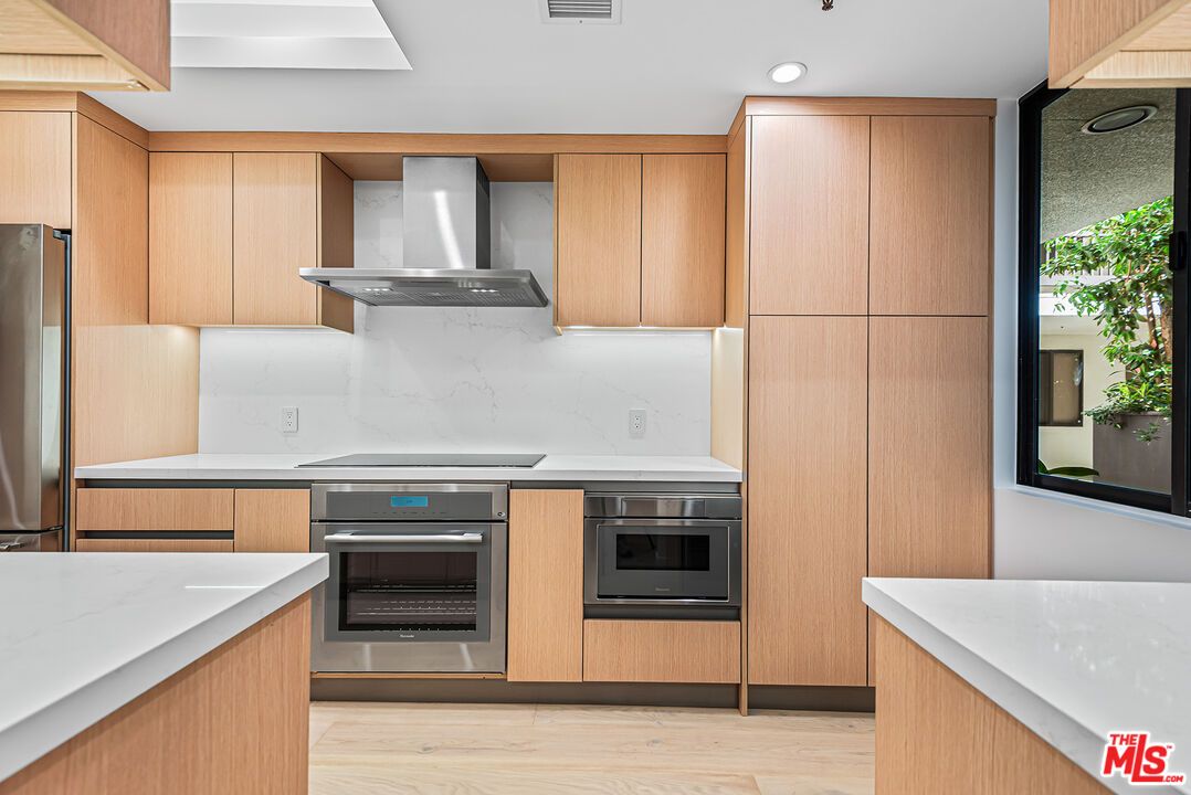 Interior, Kitchen, Marble Walls, Recessed Lighting, Stainless Steel Appliances, Wood Texture Flooring