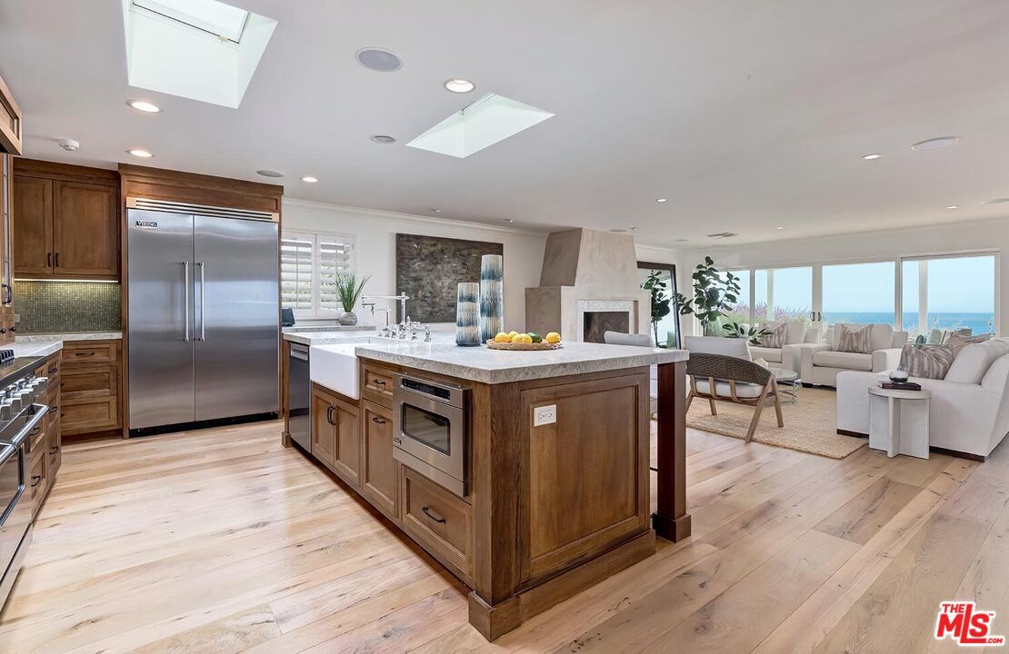 Fireplace, Interior, Kitchen, Living room, Recessed Lighting, Stainless Steel Appliances, Water, Wood Texture Flooring