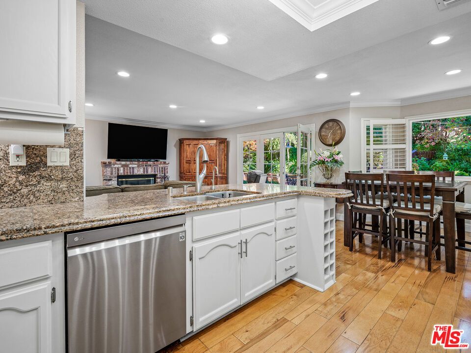 Dining room, Fireplace, Interior, Kitchen, Recessed Lighting, Stainless Steel Appliances, Wood Texture Flooring