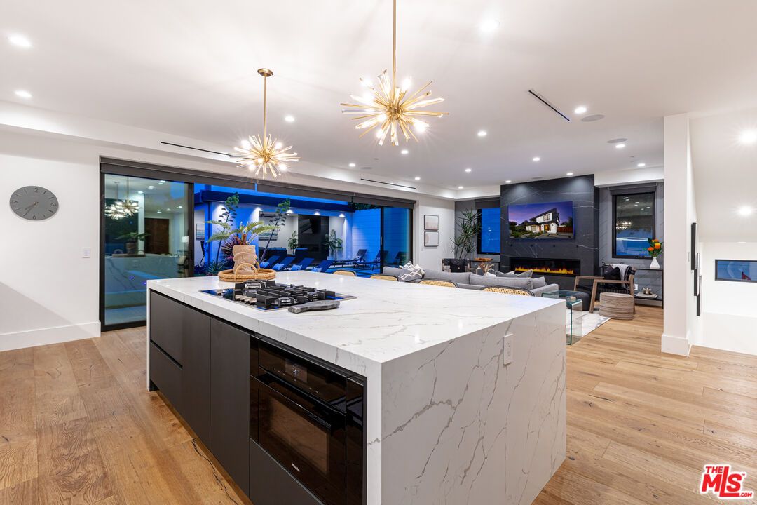 Fireplace, Interior, Kitchen, Living room, Pendant Lights, Recessed Lighting, Stainless Steel Appliances, Wood Texture Flooring