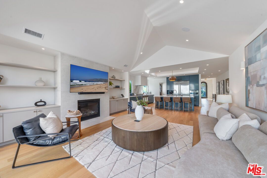Fireplace, Interior, Kitchen, Living room, Pendant Lights, Recessed Lighting, Stainless Steel Appliances, Wood Texture Flooring