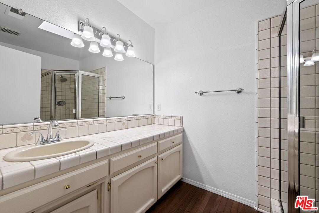 Bathroom, Dual Sink Vanities, Glass Shower, Interior, Tile Countertops, Wood Texture Flooring