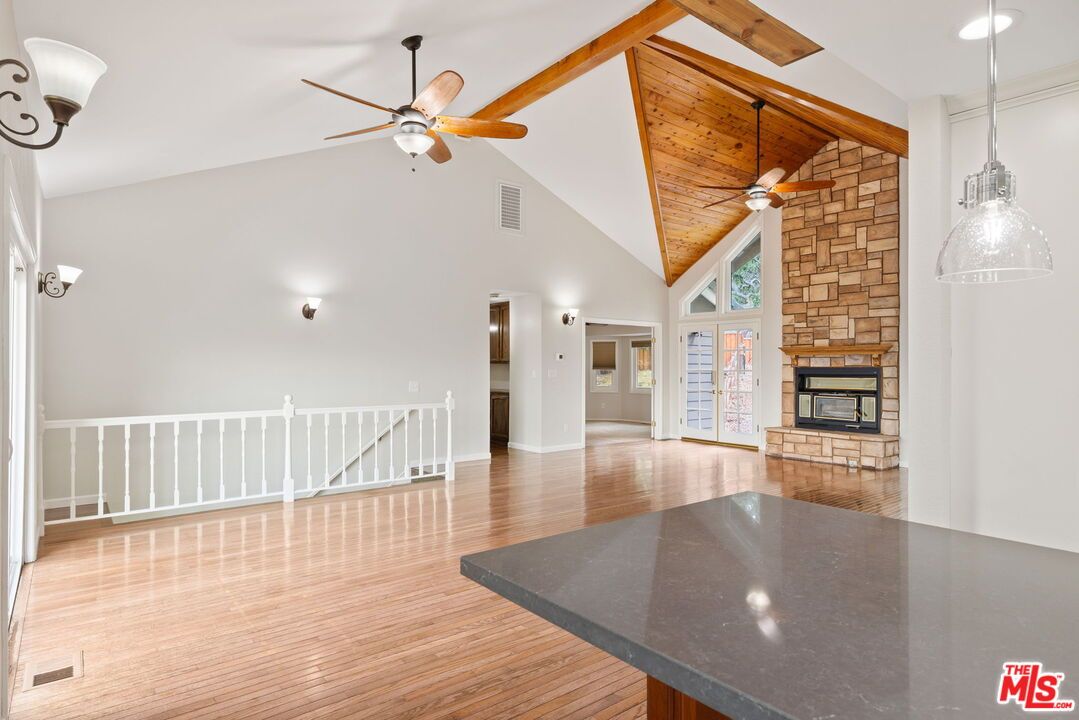 Empty room, Fireplace, Interior, Pendant Lights, Stone Walls, Wooden Beams, Wood Texture Flooring