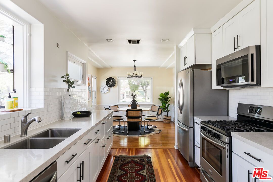 Chandelier, Dining room, Interior, Kitchen, Pendant Lights, Stainless Steel Appliances, Wood Texture Flooring