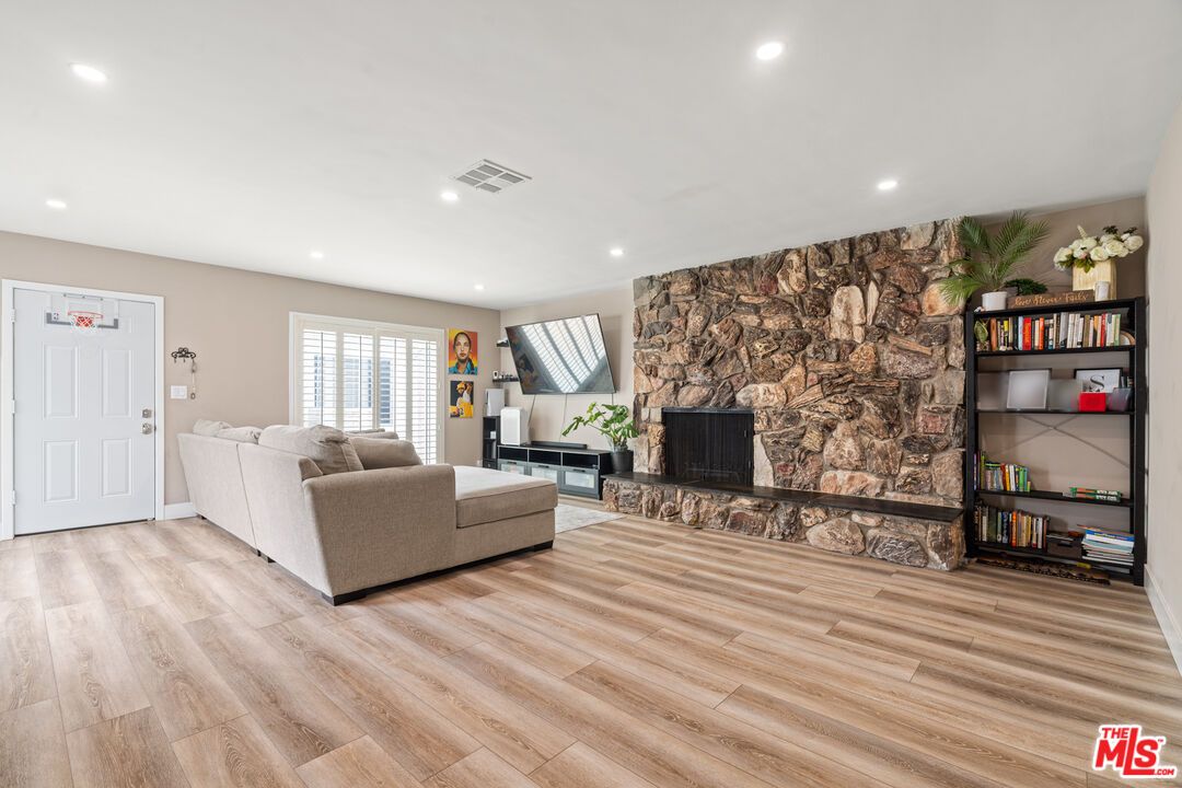 Fireplace, Interior, Living room, Recessed Lighting, Stone Walls, Wood Texture Flooring