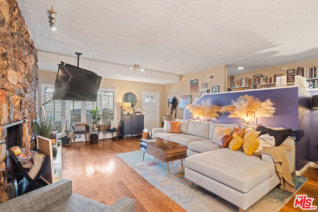 Fireplace, Interior, Living room, Recessed Lighting, Stone Walls, Wood Texture Flooring