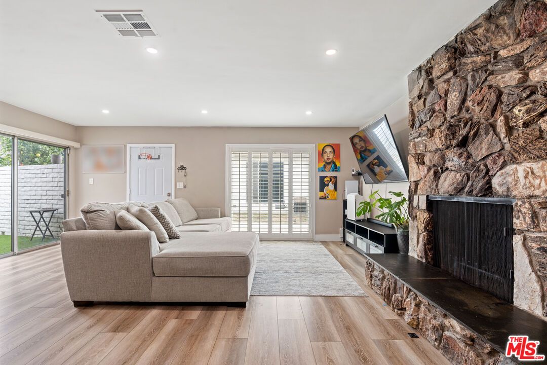 Fireplace, Interior, Living room, Recessed Lighting, Stone Walls, Wood Texture Flooring