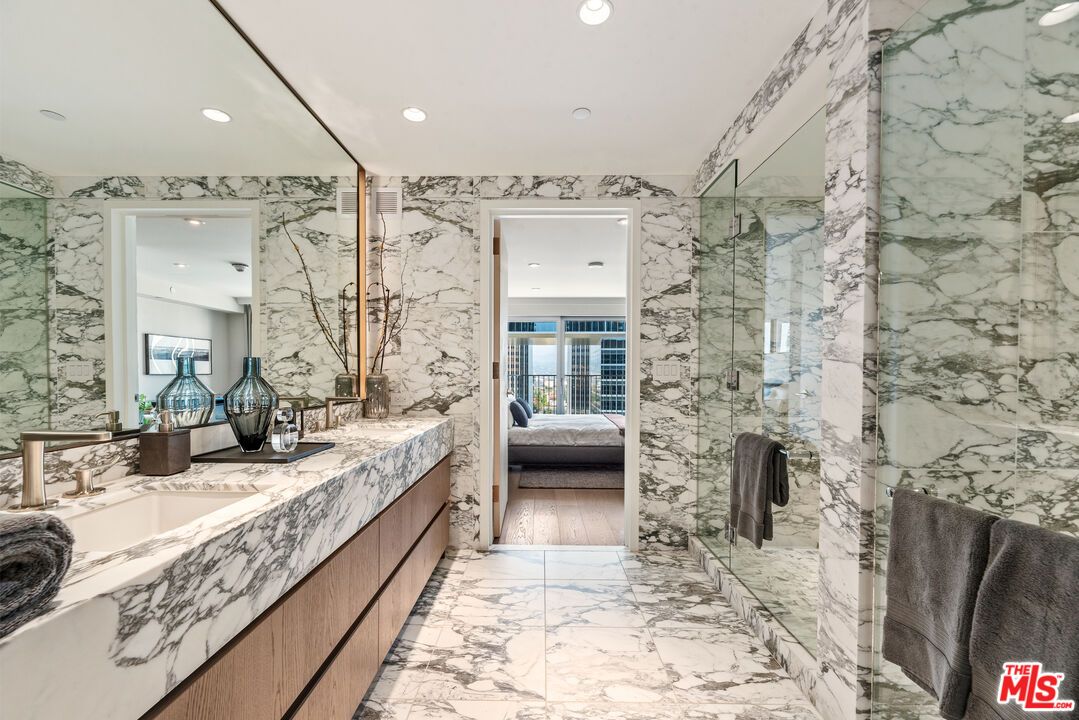 Bathroom, Dual Sink Vanities, Glass Shower, Interior, Marble, Marble Walls, Recessed Lighting, Wood Texture Flooring
