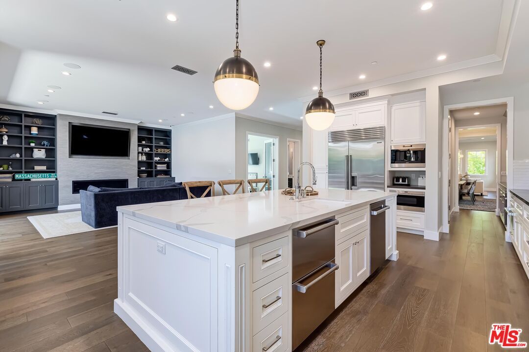 Fireplace, Interior, Kitchen, Living room, Pendant Lights, Recessed Lighting, Stainless Steel Appliances, Wood Texture Flooring