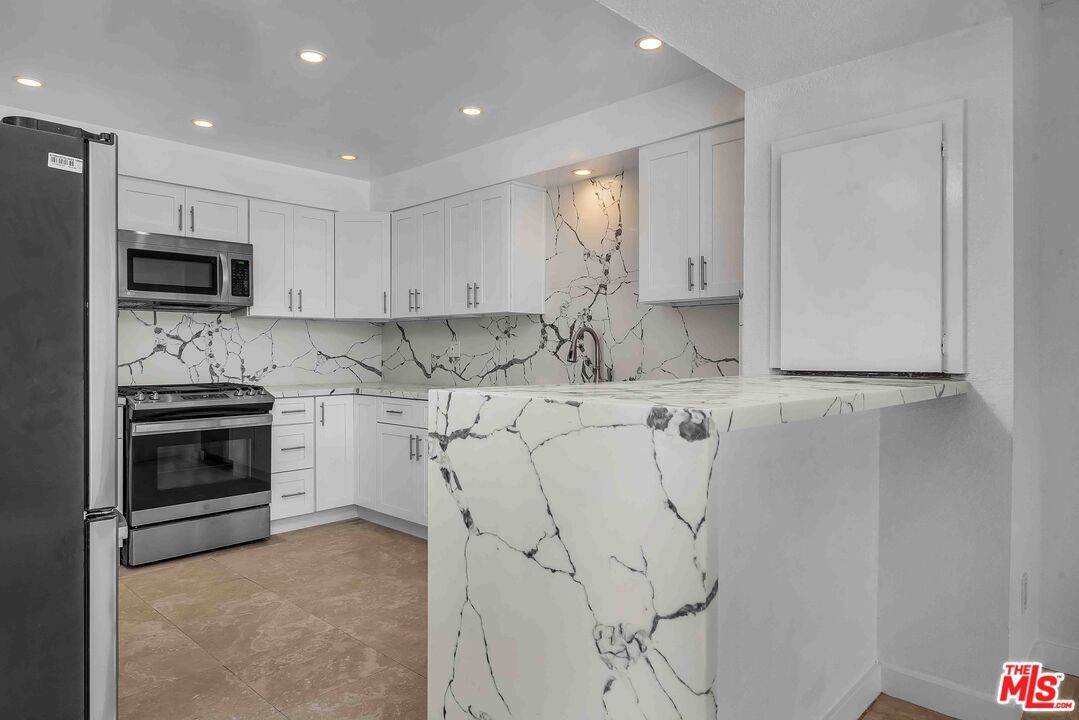 Interior, Kitchen, Marble Walls, Recessed Lighting, Stainless Steel Appliances