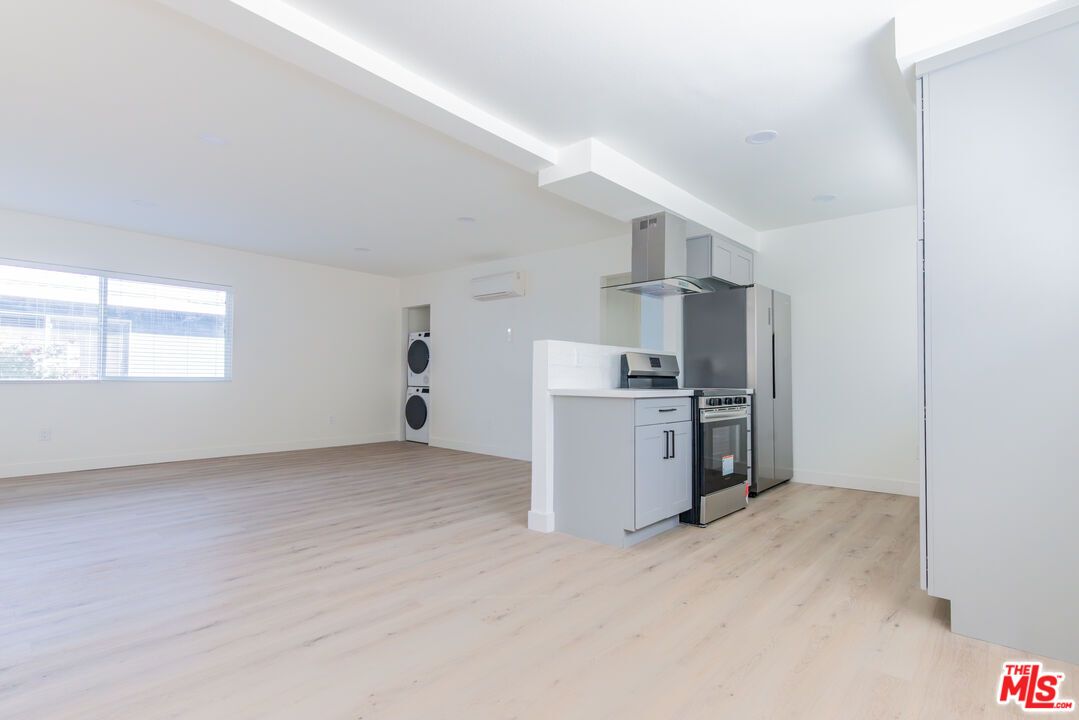 Empty room, Interior, Kitchen, Recessed Lighting, Stainless Steel Appliances, Wood Texture Flooring
