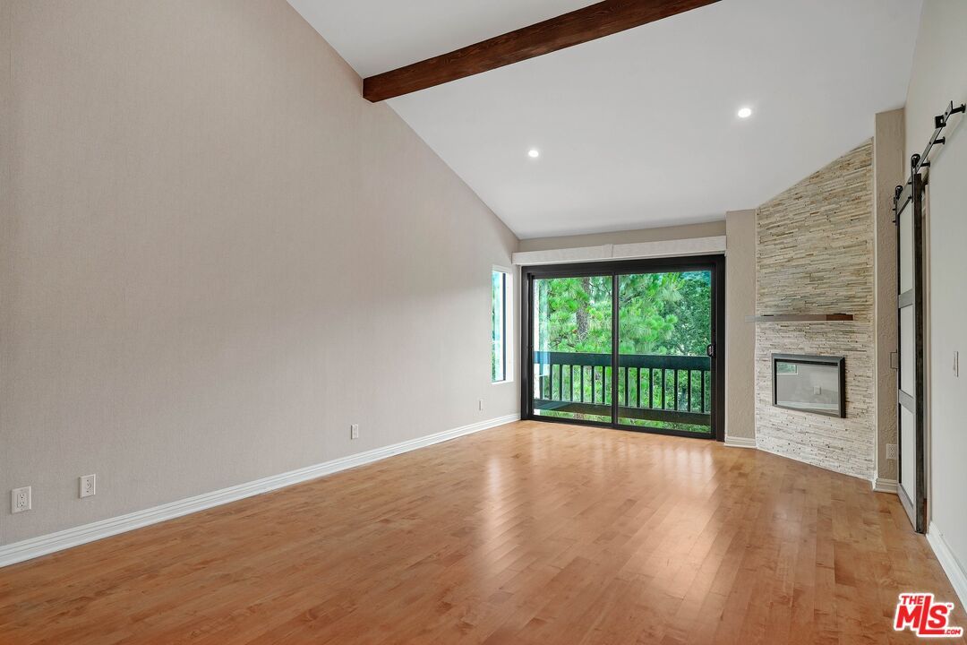 Empty room, Fireplace, Interior, Recessed Lighting, Stone Walls, Wooden Beams, Wood Texture Flooring