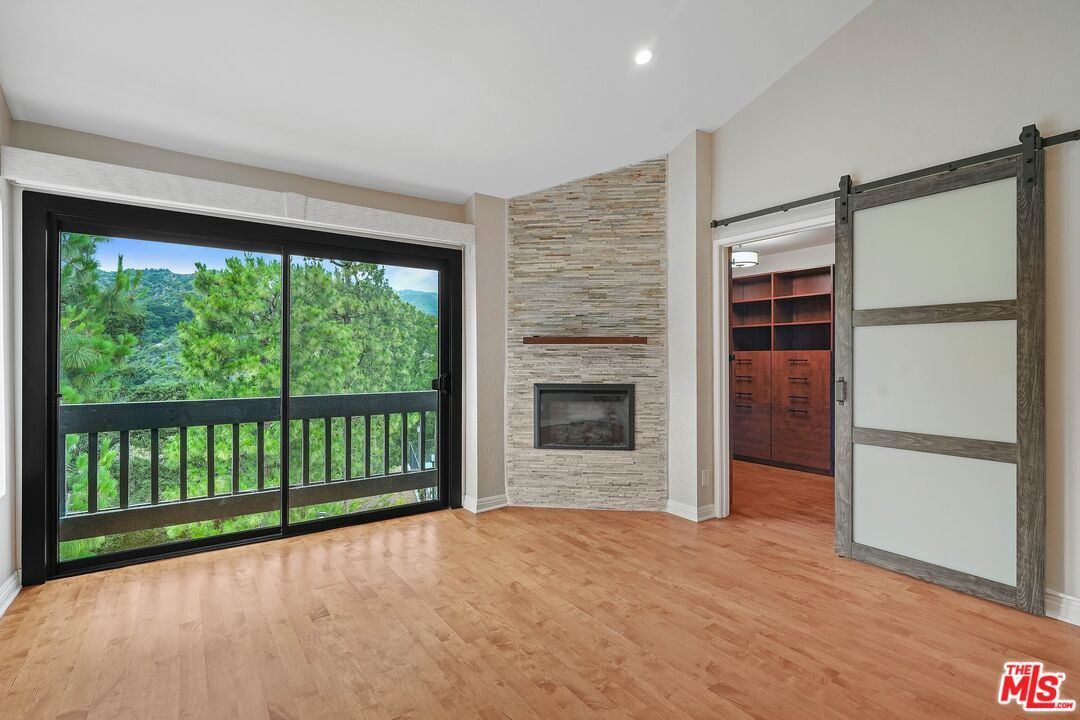 Empty room, Fireplace, Interior, Recessed Lighting, Stone Walls, Wood Texture Flooring