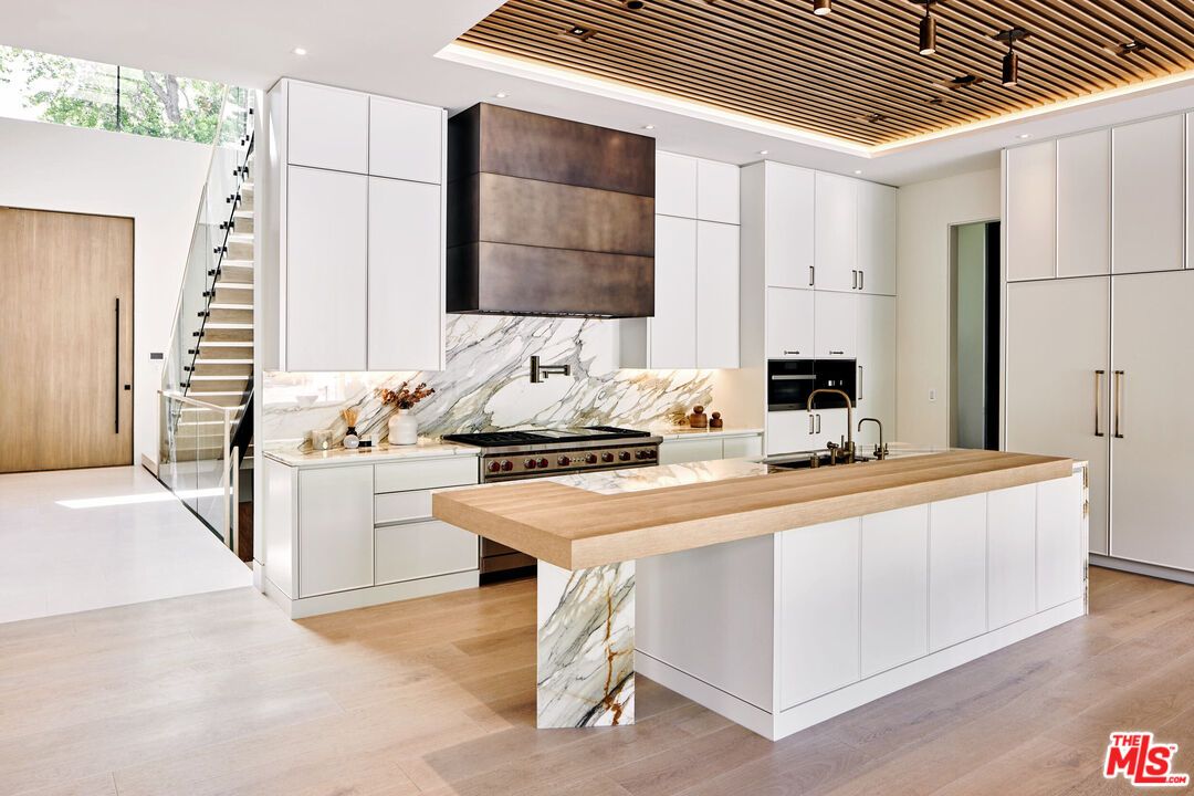 Interior, Kitchen, Marble Walls, Recessed Lighting, Stainless Steel Appliances, Wood Texture Flooring