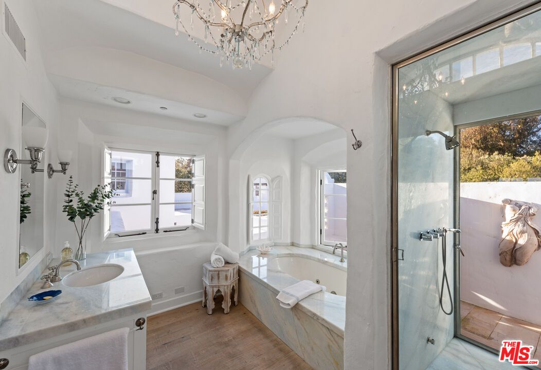 Bathroom, Chandelier, Dual Sink Vanities, Glass Shower, Interior, Wood Texture Flooring