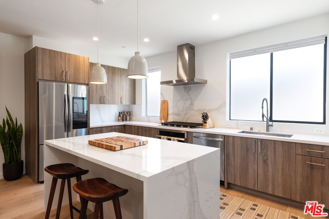 Interior, Kitchen, Marble Walls, Pendant Lights, Recessed Lighting, Stainless Steel Appliances, Wood Texture Flooring