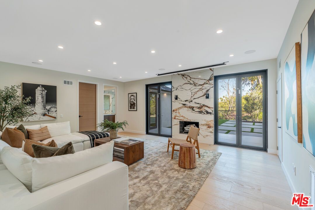 Fireplace, Interior, Living room, Marble Walls, Recessed Lighting, Wood Texture Flooring