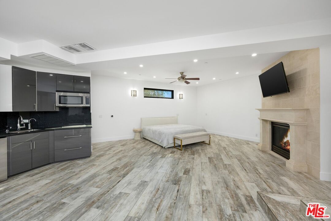 Bedroom, Fireplace, Interior, Kitchen, Recessed Lighting, Stainless Steel Appliances, Wood Texture Flooring