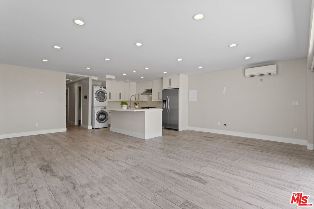 Empty room, Interior, Kitchen, Recessed Lighting, Washer, Wood Texture Flooring
