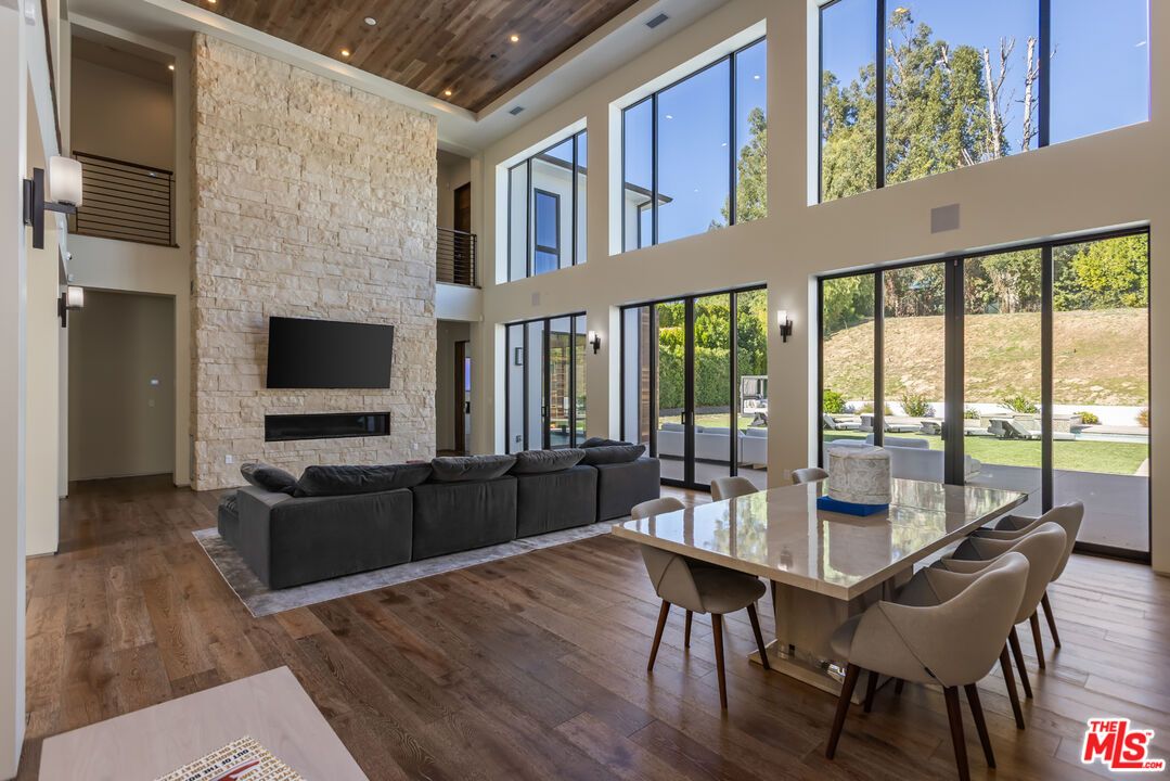 Dining room, Fireplace, Interior, Living room, Recessed Lighting, Stone Walls, Wooden Ceilings, Wood Texture Flooring