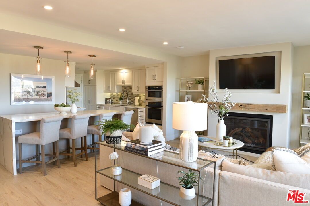 Fireplace, Interior, Kitchen, Living room, Pendant Lights, Recessed Lighting, Stainless Steel Appliances, Wood Texture Flooring