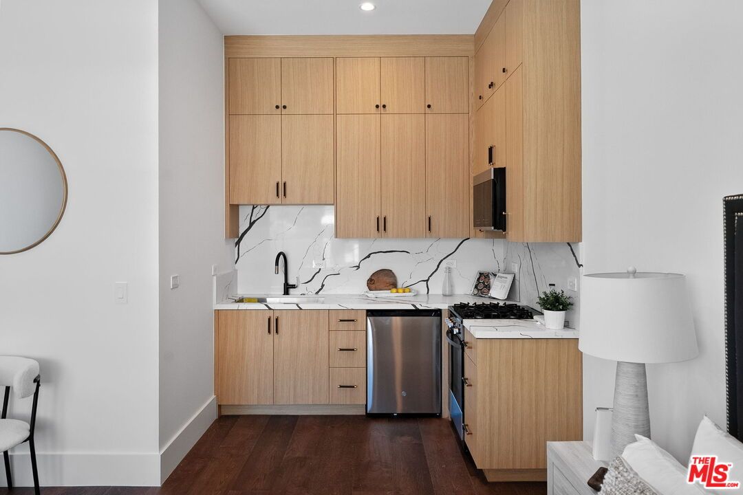 Interior, Kitchen, Marble Walls, Recessed Lighting, Stainless Steel Appliances, Wood Texture Flooring