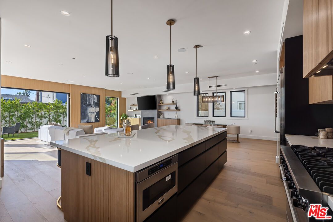 Dining room, Fireplace, Interior, Kitchen, Living room, Pendant Lights, Recessed Lighting, Stainless Steel Appliances, Wood Texture Flooring