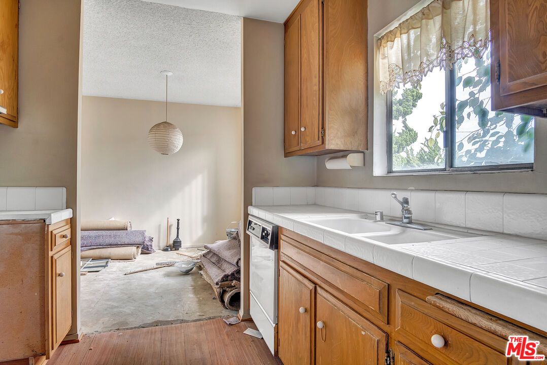 Interior, Kitchen, Pendant Lights, Tile Countertops, Wood Texture Flooring