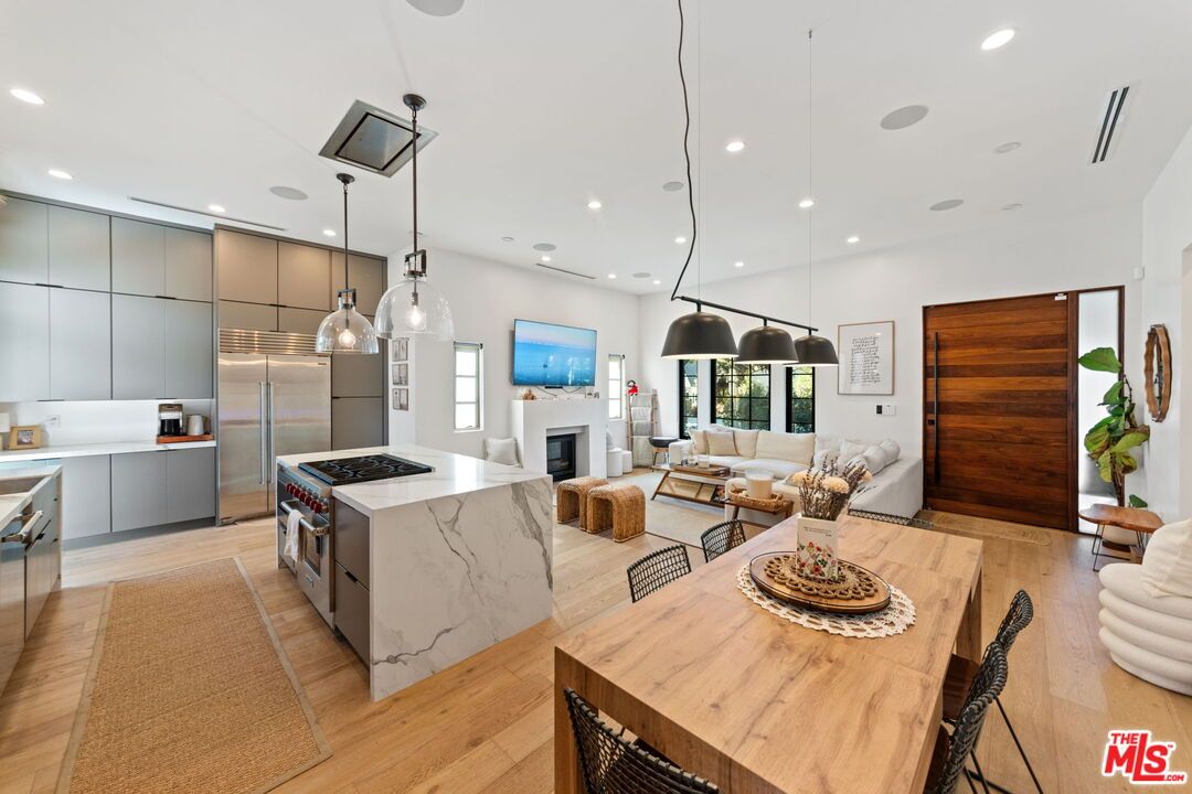 Fireplace, Interior, Kitchen, Living room, Pendant Lights, Recessed Lighting, Stainless Steel Appliances, Wood Texture Flooring