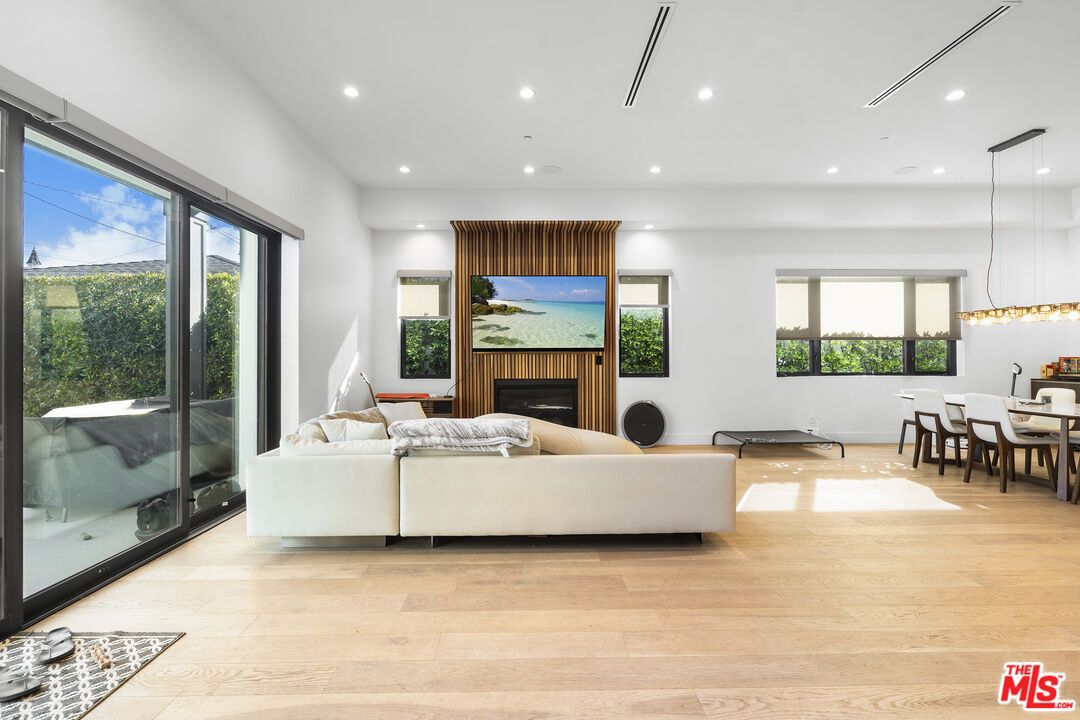 Dining room, Fireplace, Interior, Living room, Pendant Lights, Recessed Lighting, Wood Texture Flooring