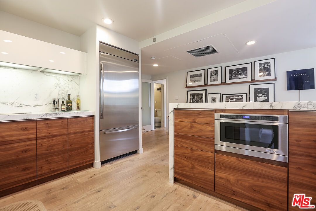 Interior, Kitchen, Marble Walls, Recessed Lighting, Stainless Steel Appliances, Wood Texture Flooring