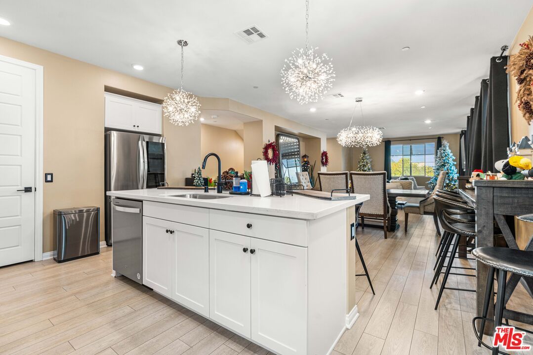 Chandelier, Dining room, Interior, Kitchen, Pendant Lights, Recessed Lighting, Stainless Steel Appliances, Wood Texture Flooring