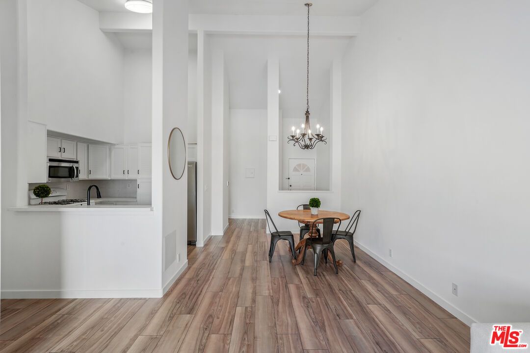 Chandelier, Dining room, Interior, Kitchen, Pendant Lights, Stainless Steel Appliances, Wood Texture Flooring