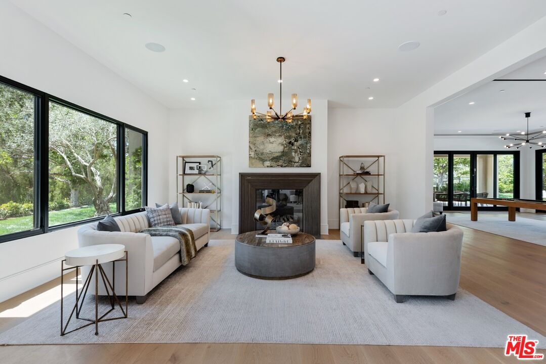 Billiard Table, Fireplace, Game Room, Interior, Living room, Pendant Lights, Recessed Lighting, Wood Texture Flooring