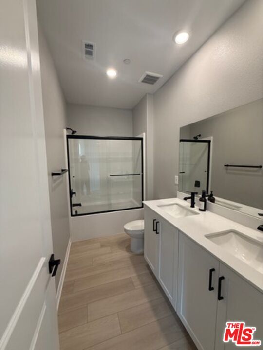 Bathroom, Dual Sink Vanities, Glass Shower, Interior, Recessed Lighting, Wood Texture Flooring